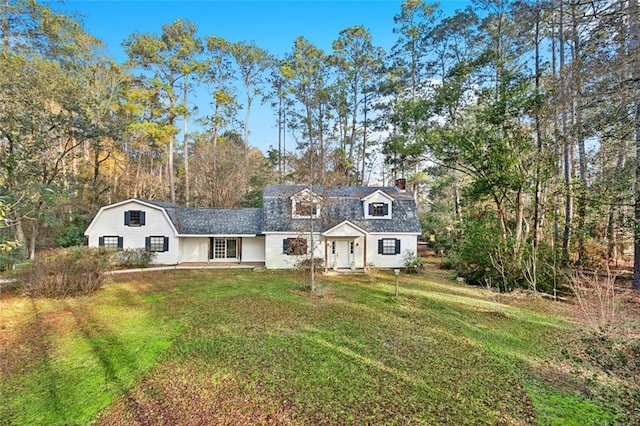 19635 Sunshine Ave, Covington, LA 70433 - view of front of house with a chimney, a gambrel roof, a front lawn, and view of scattered trees