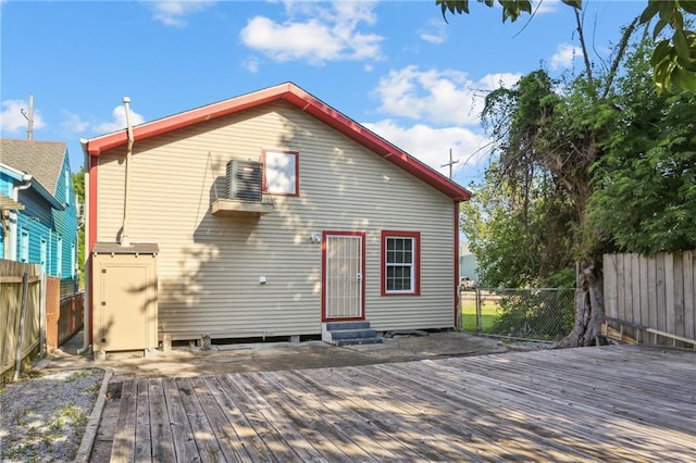 629 Lesseps St, New Orleans, LA 70117 - back of house with entry steps, a wooden deck, and a fenced backyard