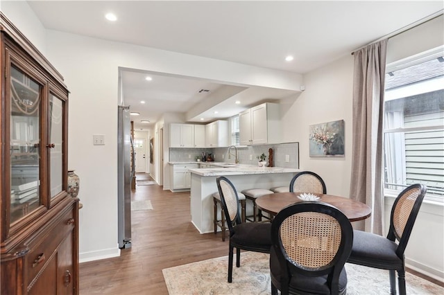 240810 Saint Anthony St, New Orleans, LA 70119 - dining area featuring healthy amount of natural light, light wood finished floors, recessed lighting, and baseboards