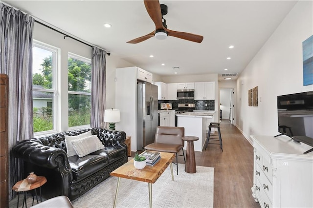 240810 Saint Anthony St, New Orleans, LA 70119 - living room with light wood finished floors, a ceiling fan, and recessed lighting