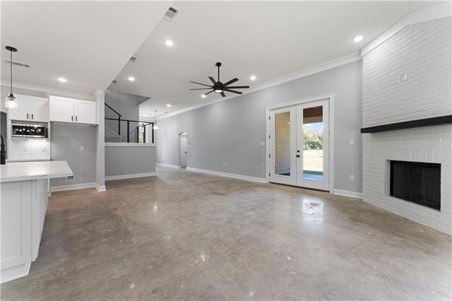 43448 Springwood Way, Hammond, LA 70401 - unfurnished living room featuring concrete flooring, a ceiling fan, ornamental molding, recessed lighting, and a fireplace