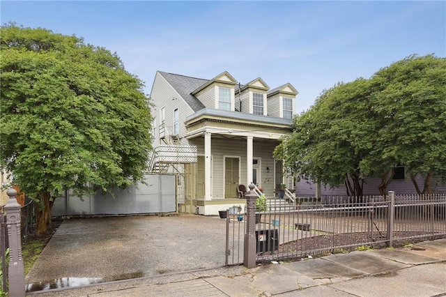 2224 Dumaine St, New Orleans, LA 70119 - view of front of house with covered porch, a fenced front yard, and a gate