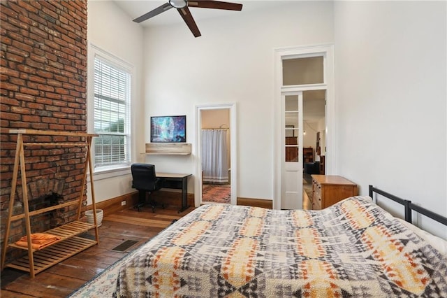 2224 Dumaine St, New Orleans, LA 70119 - bedroom with wood-type flooring, baseboards, a fireplace, an office area, and connected bathroom
