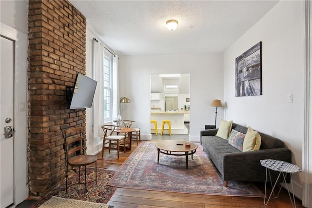 2224 Dumaine St, New Orleans, LA 70119 - living area with a textured ceiling and wood finished floors