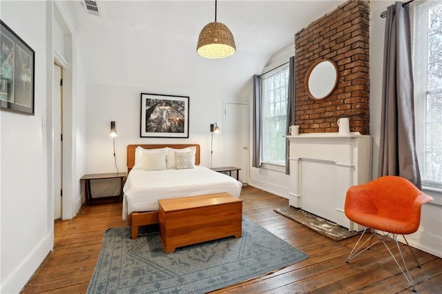 2224 Dumaine St, New Orleans, LA 70119 - bedroom with wood-type flooring, vaulted ceiling, and baseboards