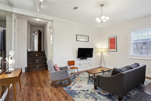 2224 Dumaine St, New Orleans, LA 70119 - living room with wood finished floors, baseboards, stairway, and a chandelier