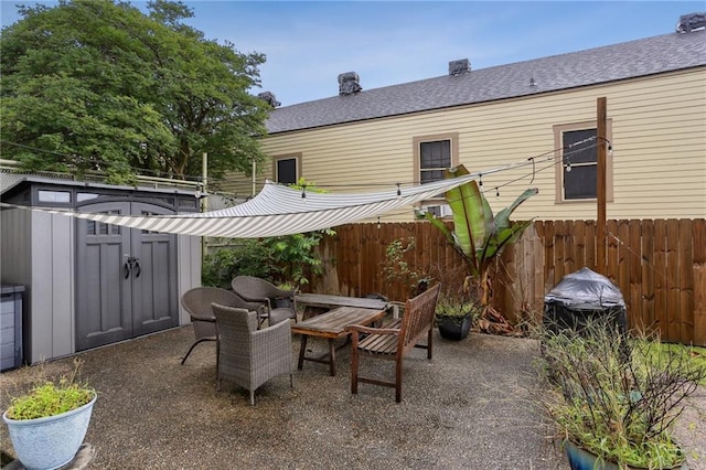 2224 Dumaine St, New Orleans, LA 70119 - view of patio / terrace with a shed, a fenced backyard, and an outbuilding