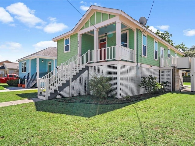 5840 Eads St, New Orleans, LA 70122 - view of front facade with stairs, a front yard, covered porch, and ceiling fan