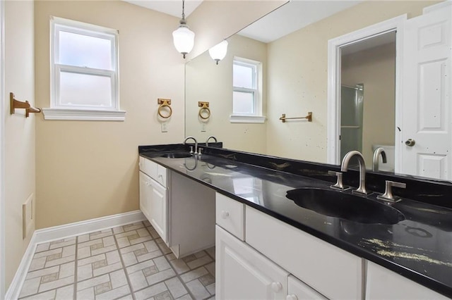 5120 Belle Dr, Metairie, LA 70006 - bathroom featuring double vanity, baseboards, and brick patterned floors