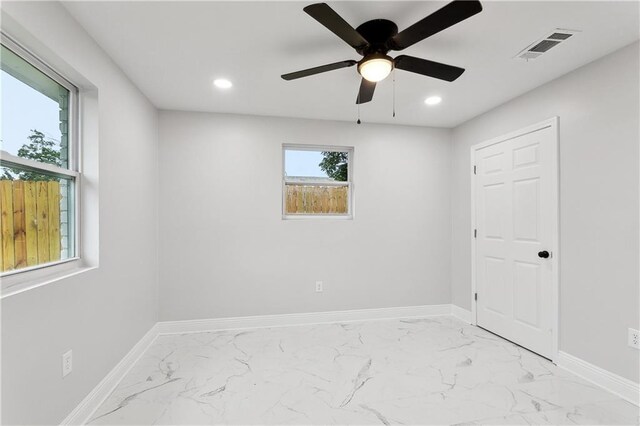 unfurnished room featuring marble look tiles, baseboards, recessed lighting, and ceiling fan