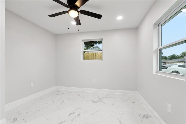spare room featuring marble finish floors, baseboards, a ceiling fan, and recessed lighting