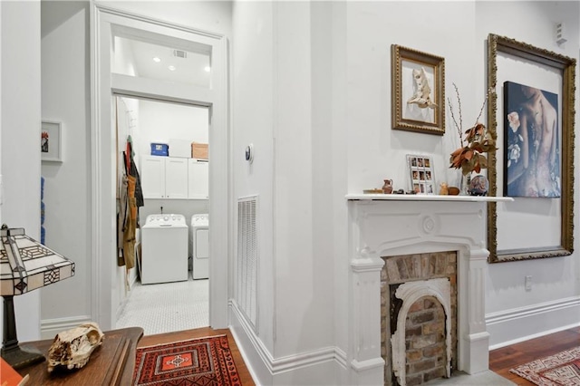 3217 Dauphine St, New Orleans, LA 70117 - hallway featuring washer and dryer, wood finished floors, and baseboards