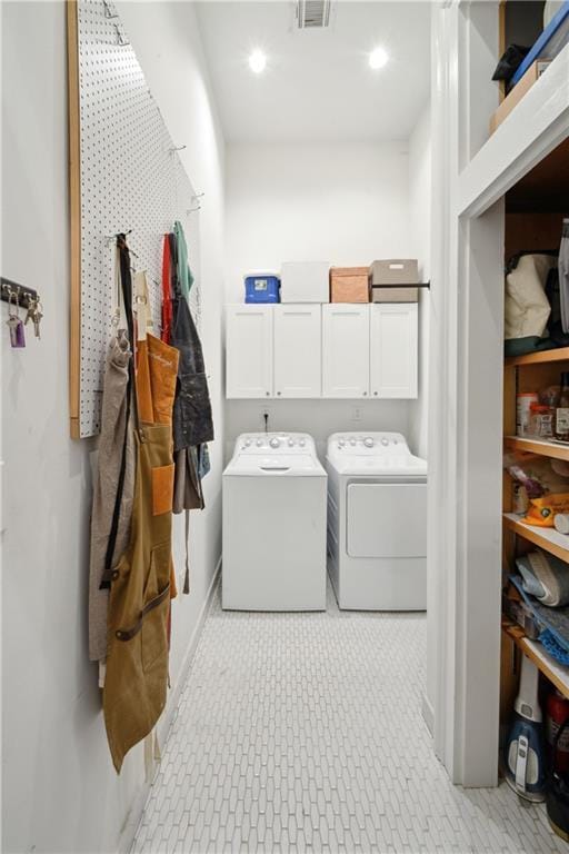 3217 Dauphine St, New Orleans, LA 70117 - clothes washing area featuring washer and dryer, cabinet space, and baseboards