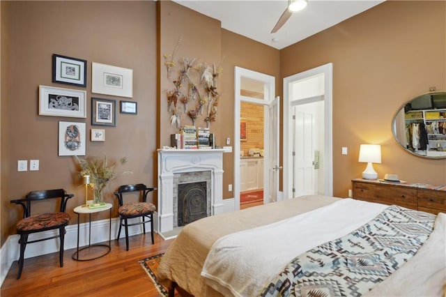 3217 Dauphine St, New Orleans, LA 70117 - bedroom featuring wood finished floors and a fireplace with raised hearth