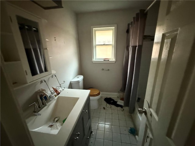 bathroom featuring toilet, tile patterned floors, vanity, and shower / bath combination with curtain