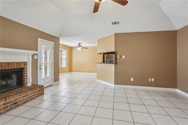 2728 Sprig Dr, Marrero, LA 70072 - unfurnished living room with a ceiling fan, vaulted ceiling, a fireplace, baseboards, and light tile patterned flooring