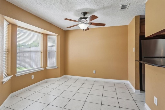 2728 Sprig Dr, Marrero, LA 70072 - unfurnished room with ceiling fan, a textured ceiling, baseboards, and light tile patterned floors