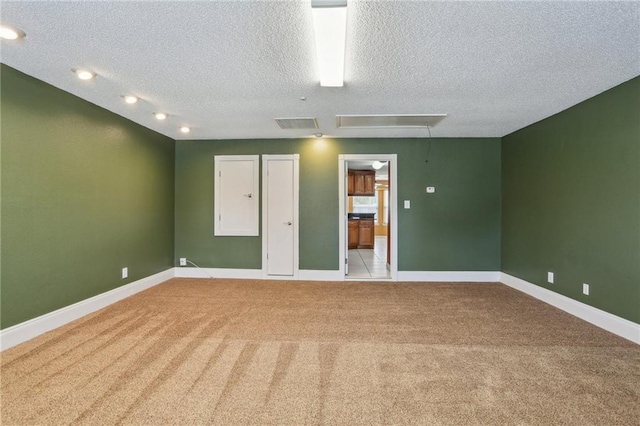2728 Sprig Dr, Marrero, LA 70072 - spare room featuring attic access, light colored carpet, a textured ceiling, and baseboards