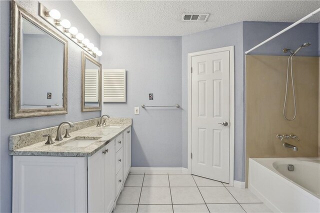 2728 Sprig Dr, Marrero, LA 70072 - full bathroom featuring tile patterned floors,  shower combination, a textured ceiling, baseboards, and double vanity