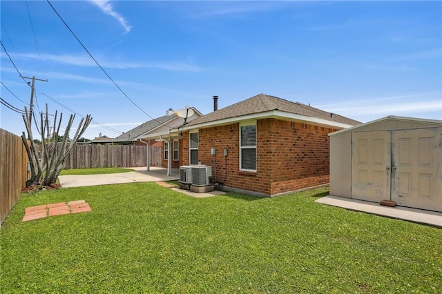 2728 Sprig Dr, Marrero, LA 70072 - back of house featuring a patio, brick siding, a storage shed, cooling unit, and an outbuilding