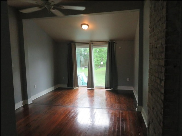spare room with hardwood / wood-style flooring, a ceiling fan, lofted ceiling, and baseboards