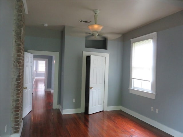 spare room with wood finished floors, baseboards, and ceiling fan