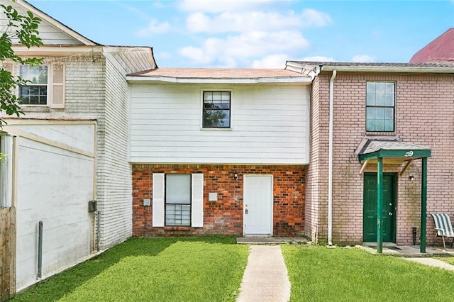 27 Pinewood Ct, New Orleans, LA 70114 - townhome / multi-family property featuring a front yard and brick siding