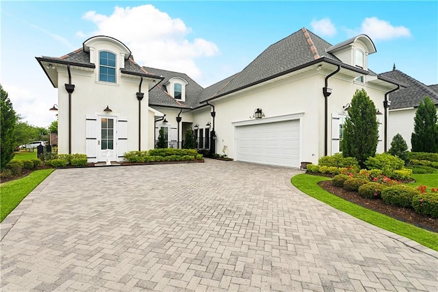 486 Cercle Du Lac, Covington, LA 70433 - french country inspired facade featuring stucco siding, a garage, and decorative driveway