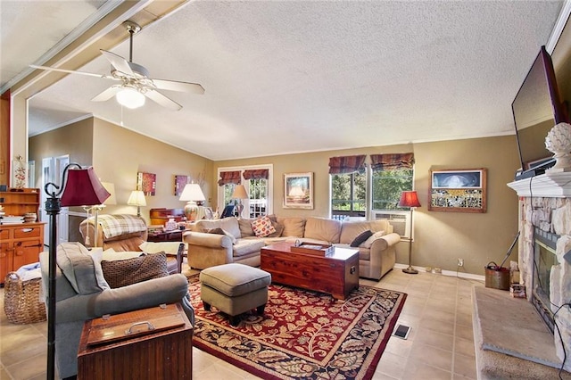 16768 Kat Kaw Rd, Franklinton, LA 70438 - living room featuring a ceiling fan, a stone fireplace, light tile patterned flooring, a textured ceiling, and baseboards