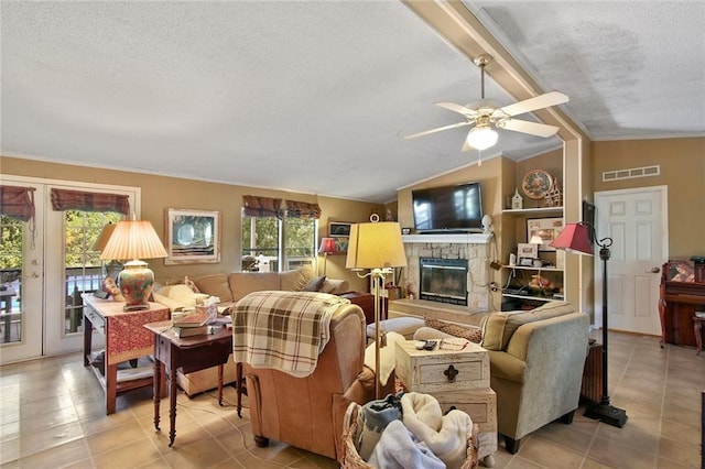 16768 Kat Kaw Rd, Franklinton, LA 70438 - living area featuring a textured ceiling, light tile patterned floors, a stone fireplace, ceiling fan, and ornamental molding