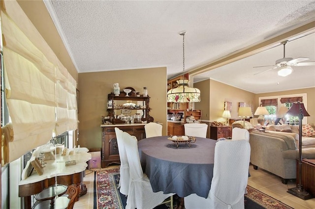 16768 Kat Kaw Rd, Franklinton, LA 70438 - dining room with light tile patterned floors, a ceiling fan, a textured ceiling, and ornamental molding