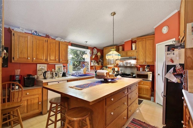 16768 Kat Kaw Rd, Franklinton, LA 70438 - kitchen featuring wooden counters, a textured ceiling, white appliances, light floors, and a kitchen island