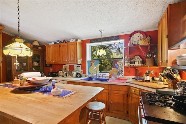 16768 Kat Kaw Rd, Franklinton, LA 70438 - kitchen featuring a sink, wood counters, a textured ceiling, hanging light fixtures, and a center island