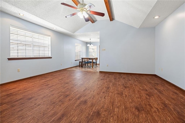 unfurnished room with wood finished floors, a textured ceiling, ceiling fan, a chandelier, and baseboards