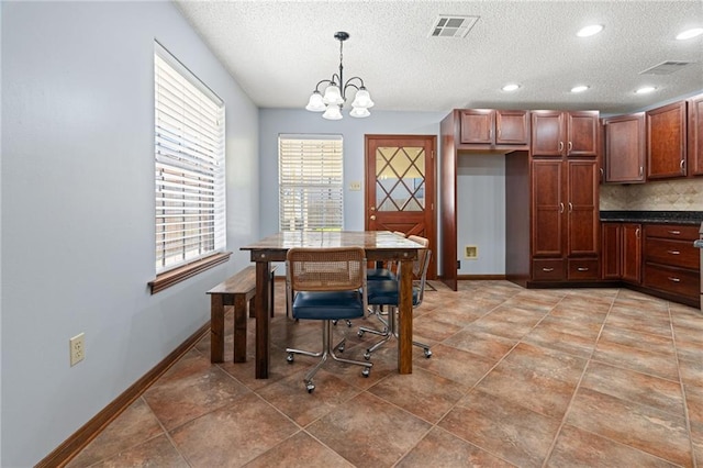 dining space with a chandelier, a textured ceiling, baseboards, plenty of natural light, and recessed lighting