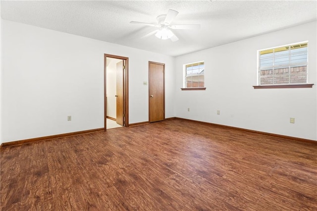 unfurnished bedroom with wood finished floors, baseboards, a textured ceiling, and a ceiling fan
