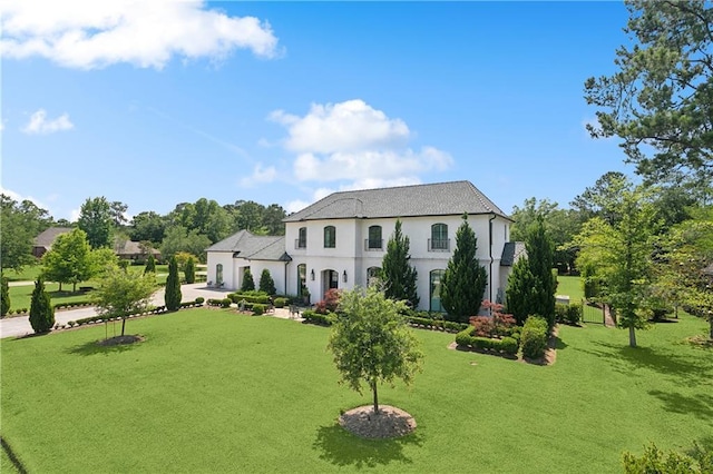181 Windermere Way, Madisonville, LA 70447 - view of front facade with concrete driveway, a front yard, stucco siding, and a garage