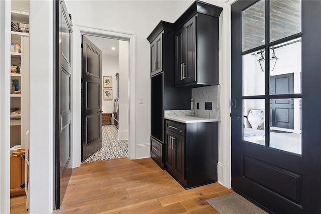 181 Windermere Way, Madisonville, LA 70447 - kitchen with dark cabinetry, light countertops, light wood-type flooring, and baseboards