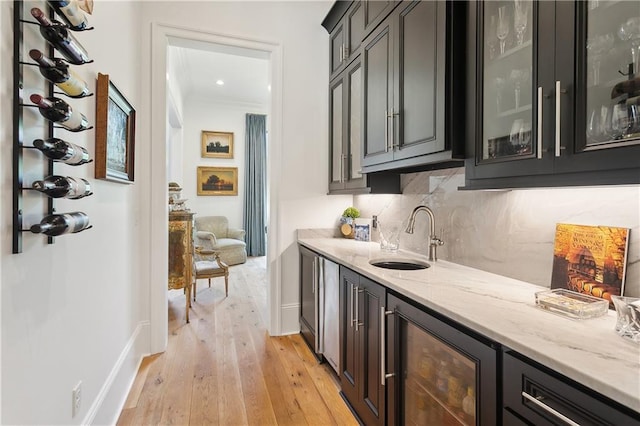 181 Windermere Way, Madisonville, LA 70447 - indoor wet bar featuring beverage cooler, light wood-type flooring, backsplash, baseboards, and crown molding