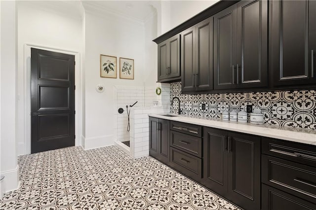 181 Windermere Way, Madisonville, LA 70447 - laundry area featuring a sink, crown molding, tile patterned flooring, and baseboards