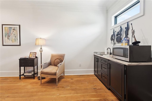 181 Windermere Way, Madisonville, LA 70447 - sitting room featuring baseboards, crown molding, and light wood-style floors