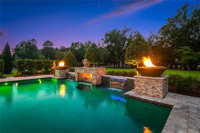 181 Windermere Way, Madisonville, LA 70447 - pool at dusk with an outdoor pool and a fire pit