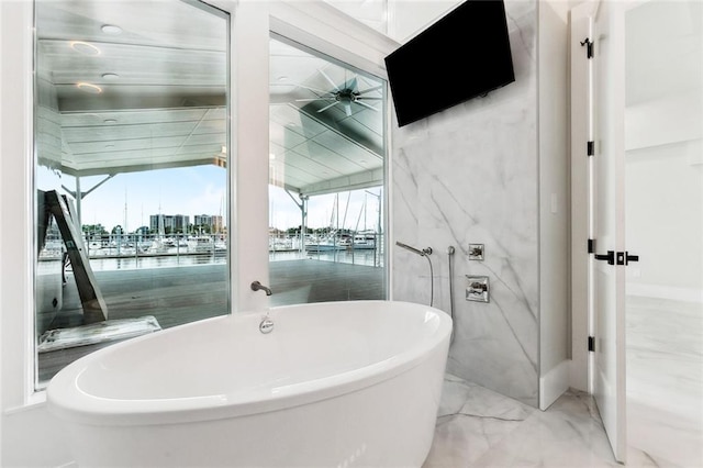 8116 Breakwater Dr, New Orleans, LA 70124 - bathroom with a water view, plenty of natural light, a freestanding tub, and marble finish flooring