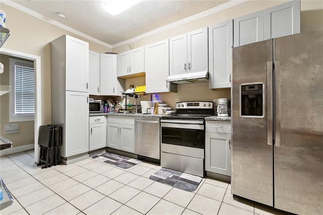 934 Brooklyn St, New Orleans, LA 70114 - kitchen with appliances with stainless steel finishes, under cabinet range hood, ornamental molding, a textured ceiling, and light tile patterned floors