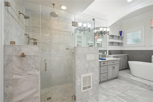 full bath featuring tile walls, ornamental molding, a shower stall, a freestanding bath, and vanity