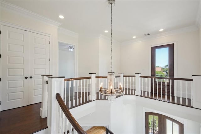 corridor featuring an upstairs landing, a chandelier, plenty of natural light, recessed lighting, and crown molding