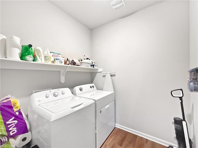 4502 Marais River Dr, Slidell, LA 70461 - clothes washing area with washer and dryer, wood finished floors, and baseboards