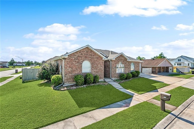 3945 Jean Lafitte Pkwy, Chalmette, LA 70043 - ranch-style home featuring brick siding, driveway, a front yard, and a residential view