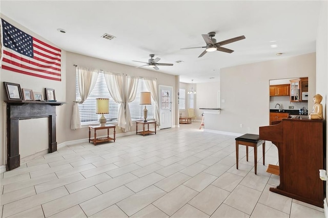3945 Jean Lafitte Pkwy, Chalmette, LA 70043 - sitting room featuring a ceiling fan, baseboards, a chandelier, and light tile patterned floors