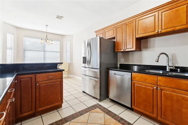 3945 Jean Lafitte Pkwy, Chalmette, LA 70043 - kitchen featuring stainless steel appliances, a sink, light tile patterned floors, a chandelier, and brown cabinets